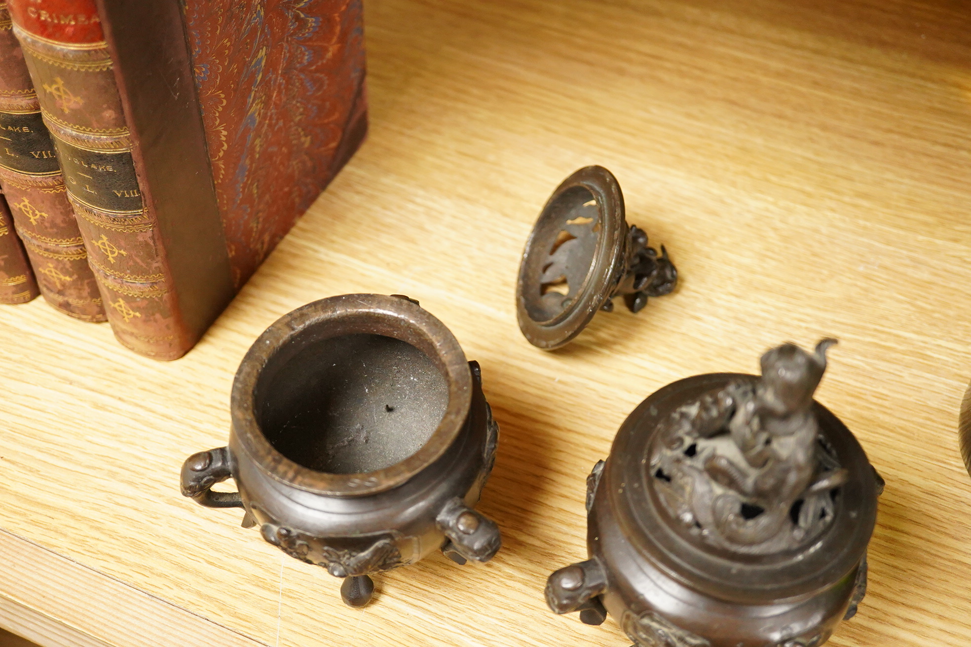 A pair of Japanese bronze koros raised on tripod feet, 19th century, 14cm high